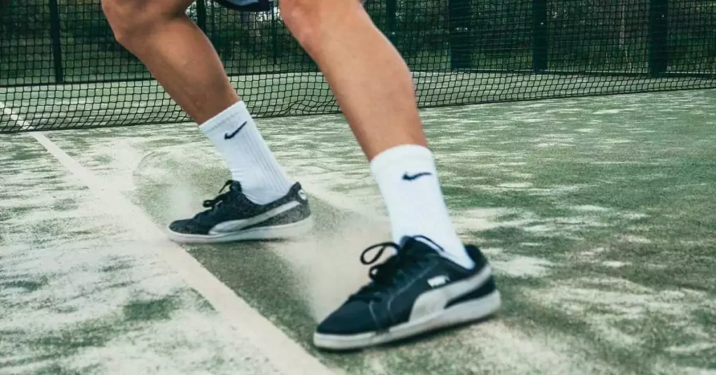 player sliding in tennis shoes