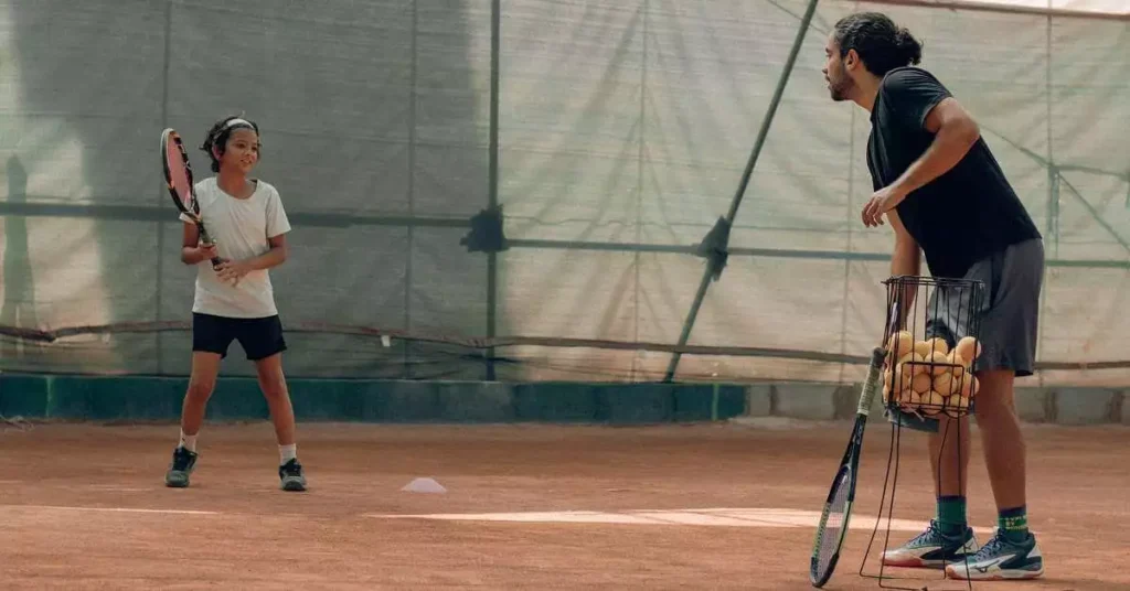 tennis coach coaching kid