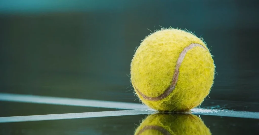 Tennis ball on a reflective surface