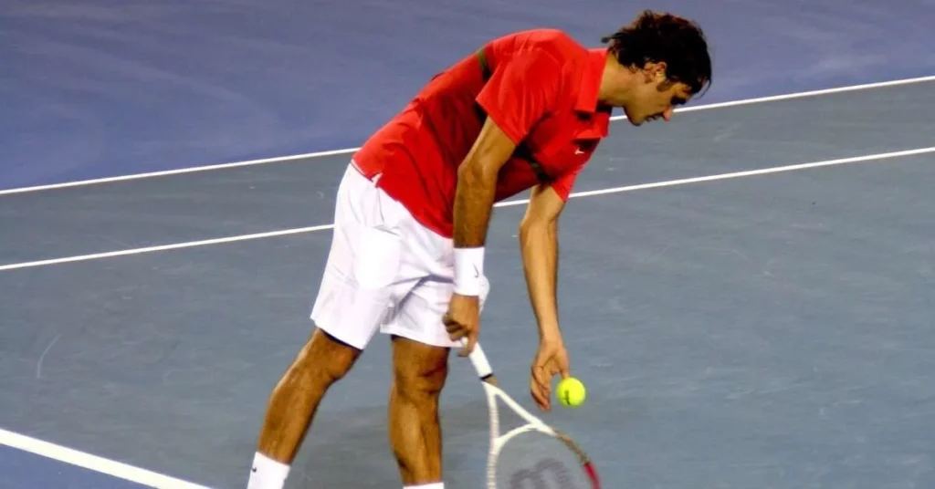 Roger Federer serving the tennis ball